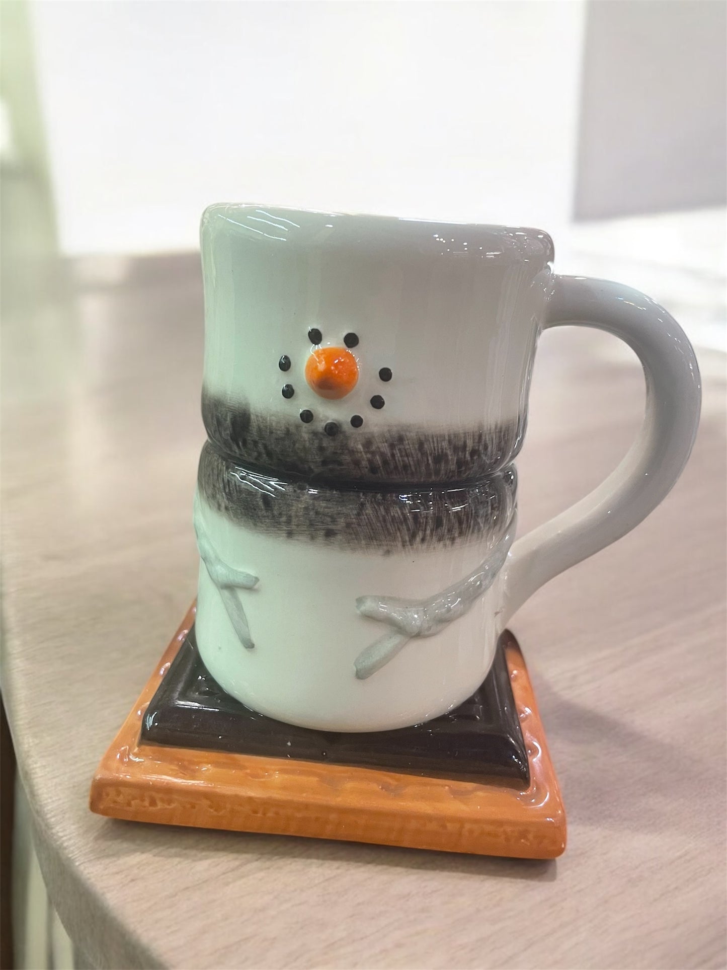 Snowman mug sitting on top of a coaster (12.5 cm)